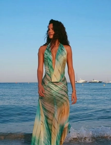 Detail of deep V-neck halter maxi dress with green and blue wavy artistic print