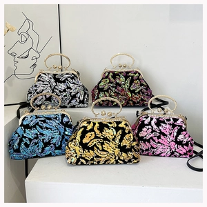 Close-up of sparkling sequin evening bags in silver, green, blue, gold and pink colors