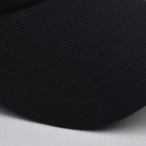 Macro shot of black twill fabric baseball cap showing detailed stitching and textile texture