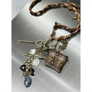 Handmade punk long necklace with dolphin, keys, and heart charms on woven leather strap