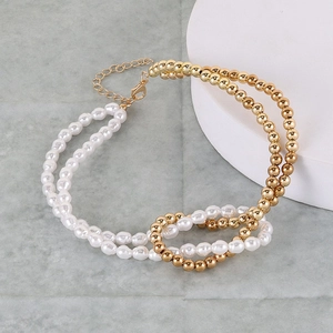 Detail of faux pearl and gold bead layered necklace with lobster clasp and extension chain