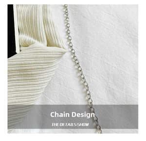 Detail showing the silver metal chain and vertical ribbed texture of the cream mini bag
