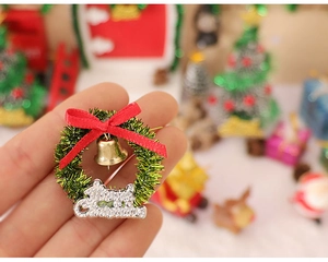 Close-up of a miniature Christmas wreath with a red bow and Merry Christmas sign