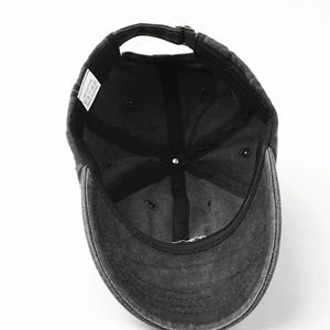 Detailed interior view of washed black cotton baseball cap with labels and stitching