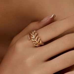 Luxurious gold leaf open ring with pavé-set zircons shown on a model's hand