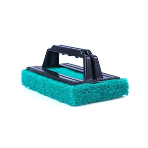 Detail view of kitchen cleaning brush with long black handle and green scrubbing pad