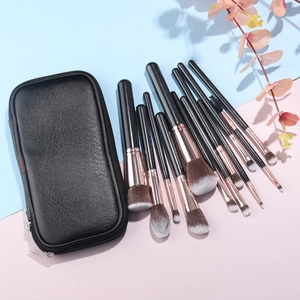 Detailed set of 12 black and gold professional makeup brushes with a portable PU travel case