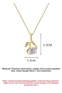 Macro detail of gold swan pendant with zircon showing exact dimensions of 2.2cm by 1.3cm