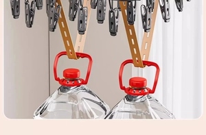 Detail of durable laundry drying rack showing strong load-bearing capacity with water buckets