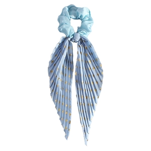 Macro shot of light blue pleated satin scrunchie with long ribbons and gold cross pattern