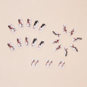 Detail of Chinese ink painting style press-on nails with red plum blossoms motif