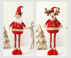 Detail of red plush Santa and reindeer figurines with snowflake embroidery and gold accents