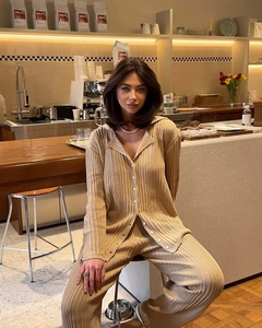 Detail of oat-colored ribbed knit two-piece set with a polo collar and matching trousers
