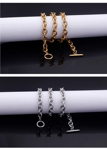 Close-up of gold and silver stainless steel O-link necklaces with OT toggle clasps
