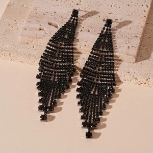Close-up of black rhinestone fringe earrings with geometric leaf-shaped hollow design