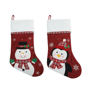 Christmas stockings with embroidered snowman and penguin patterns on red burlap and plush