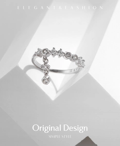 Detail of s925 silver ring with sparkling crystal cluster and dangling geometric pendant
