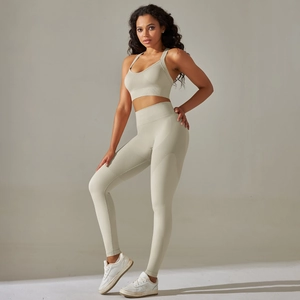 Beige ribbed seamless yoga set featuring a racerback sports bra and high-waisted leggings