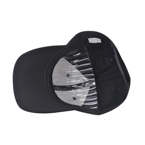 Detail view of the black baseball cap interior with polyester tag and plastic snapback