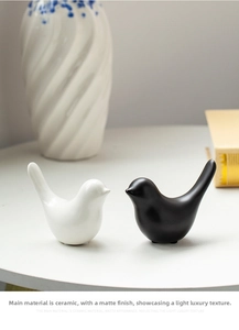 Detailed view of matte black and white ceramic bird figurines for modern home decor