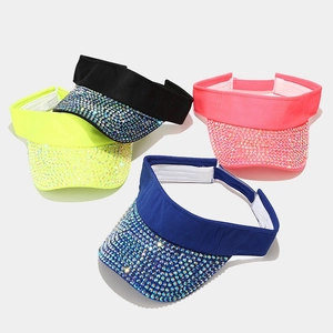 Detailed top view of colorful rhinestone sun visors in yellow, black, pink, and blue