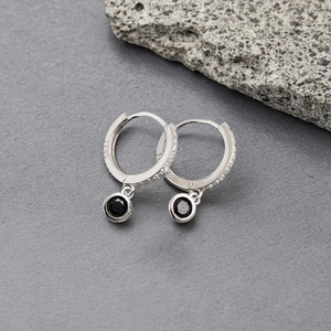 Close-up of S925 silver hoop earring with black gemstone and micro-pave zirconia
