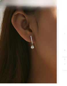 Close-up of s925 silver pear-cut droplet earring featuring micro-pave crystals