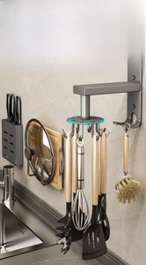 Detail of 360-degree rotating wall hook with 6 slots holding kitchen utensils and brushes