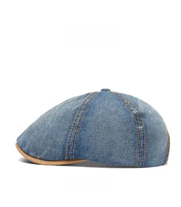 Close-up of washed denim duckbill cap with contrast stitching and leather brim detail