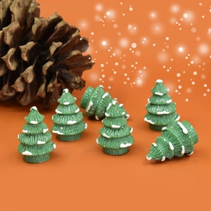 Miniature resin Christmas trees with white snow effect and pinecone holiday decoration