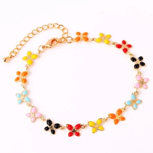 Detail of gold chain bracelet featuring colorful butterfly charms and lobster clasp