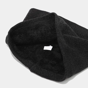 Detail showing the thick black fleece lining and fine knit texture of the winter hat