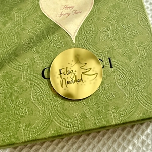 Green Paisley textured Christmas gift box with Feliz Navidad gold tag and heart sticker