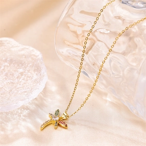 Exquisite gold dragonfly pendant necklace with colorful zircons on champagne satin background