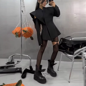 Slim-fit black blazer with unique cut-out design and boots in a trendy aesthetic look
