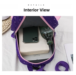 Interior view showing the storage capacity of the purple rocket toddler backpack with dots