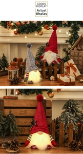 Close-up of glowing LED Christmas gnomes with knitted hats in warm festive settings