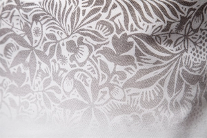 Close-up of khaki cotton fabric with tropical gradient floral prints and fine texture
