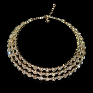 Macro detail of multilayer gold-plated choker necklace with sparkling clear crystals