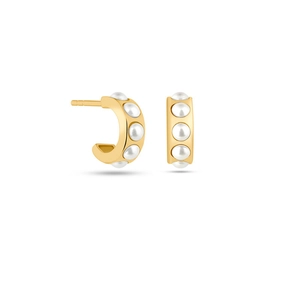 Macro detail of gold C-shape stud earrings with inlaid pearls in minimalist style