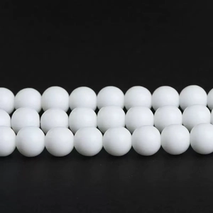 Close-up of polished white round sunstone loose beads for DIY jewelry making accessories