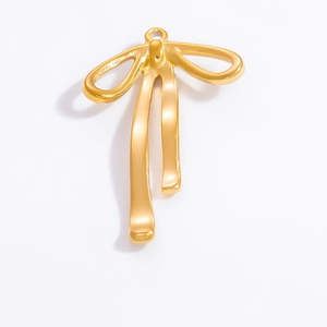 Detailed macro shot of a shiny 18k gold-plated bowknot pendant accessory with smooth finish
