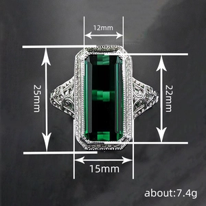 Vintage silver ring with emerald cut green gemstone and intricate hollow carving