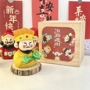 Detail of hand-carved God of Wealth wooden figurine with premium gift box packaging