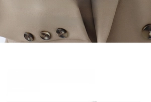 Macro detail of khaki twill blazer lapel with three dark brown tortoiseshell resin buttons