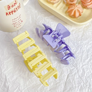 Matte large shark hair clips in pastel yellow and purple for thick hair styling
