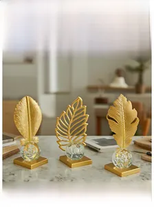 Three-piece gold metal leaf sculptures with bubble crystal balls on marble bases