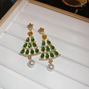 Macro detail of Christmas tree earrings with green crystals, diamonds and white pearls
