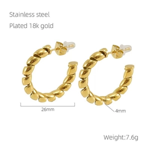 Detailed view of 26mm twisted gold hoop earrings with stainless steel and 18k gold plating