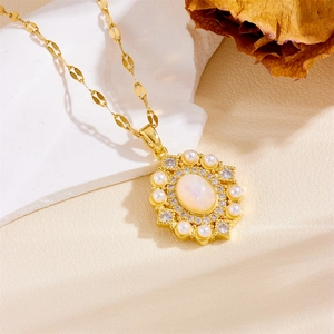 Detailed view of golden heart and moon pendant necklace with opal and pearl accents